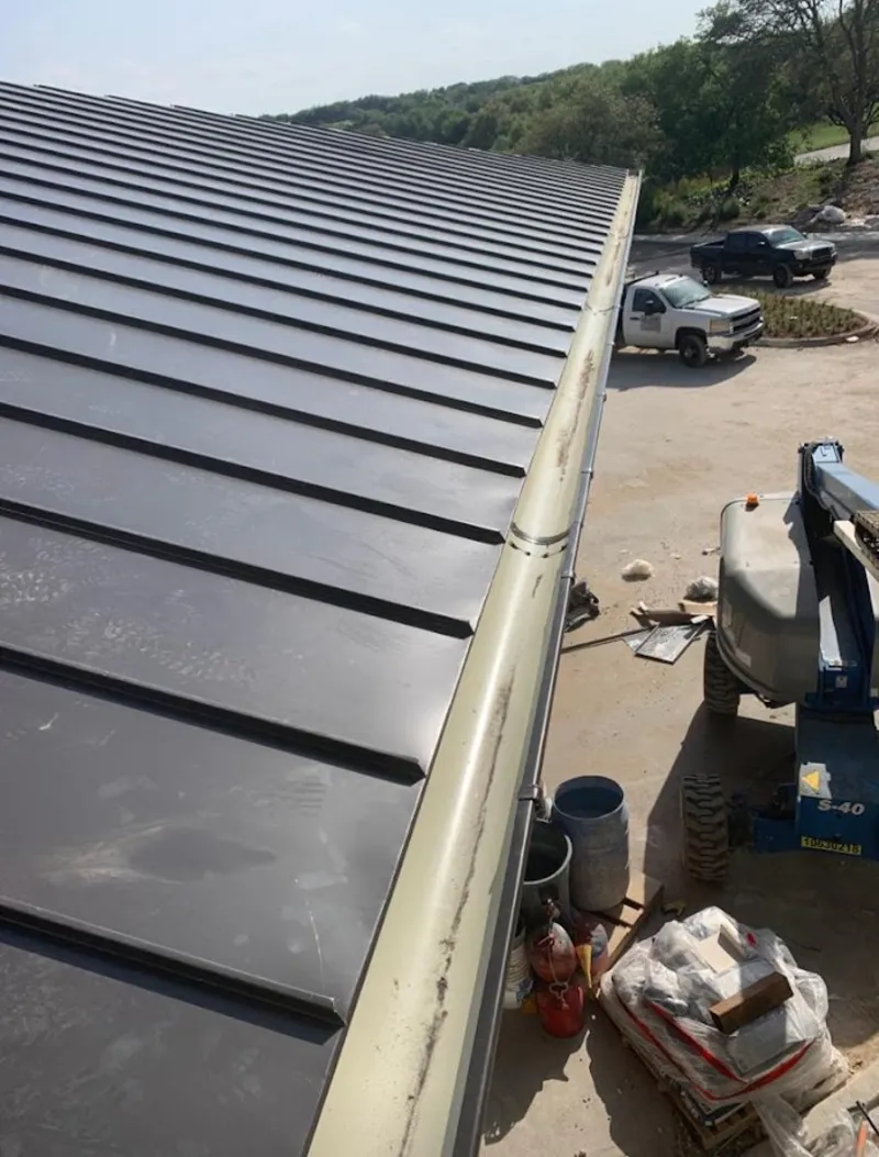 Standing seam panel and gutter detail on a metal roofing jobsite in East Hampton
